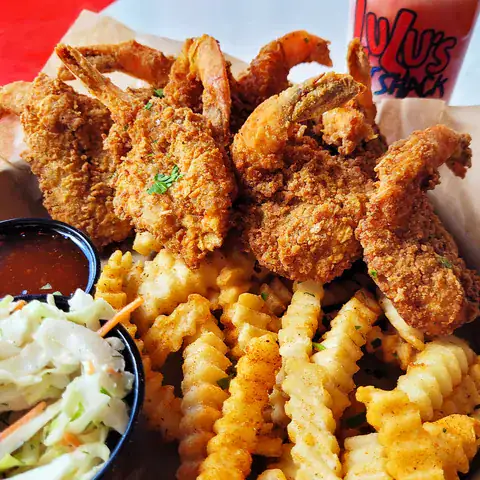 Coconut-crusted shrimp platter with fries, slaw and dipping sauce